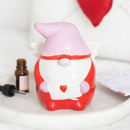 Red gnome figurine with a heart on a white surface