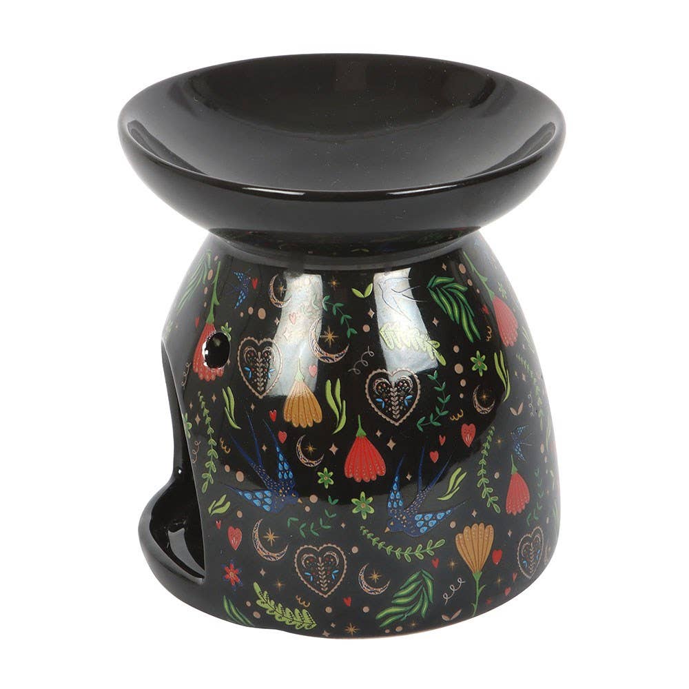 Decorative oil burner with colorful patterns on a black background