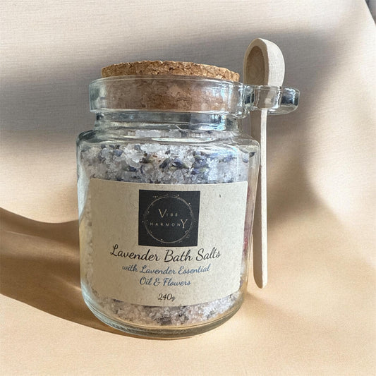 Jar of lavender bath salts with a cork lid on a beige background