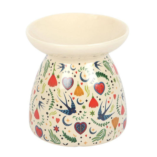 Decorative ceramic oil burner with colorful patterns on a white background