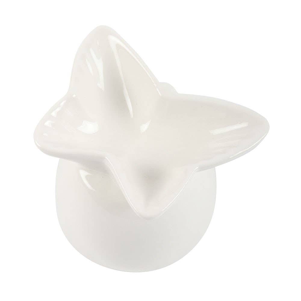 White ceramic star-shaped object on a white background