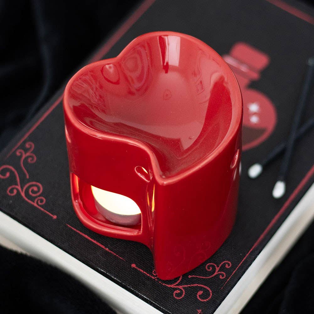 Red heart-shaped object on a black surface with red text